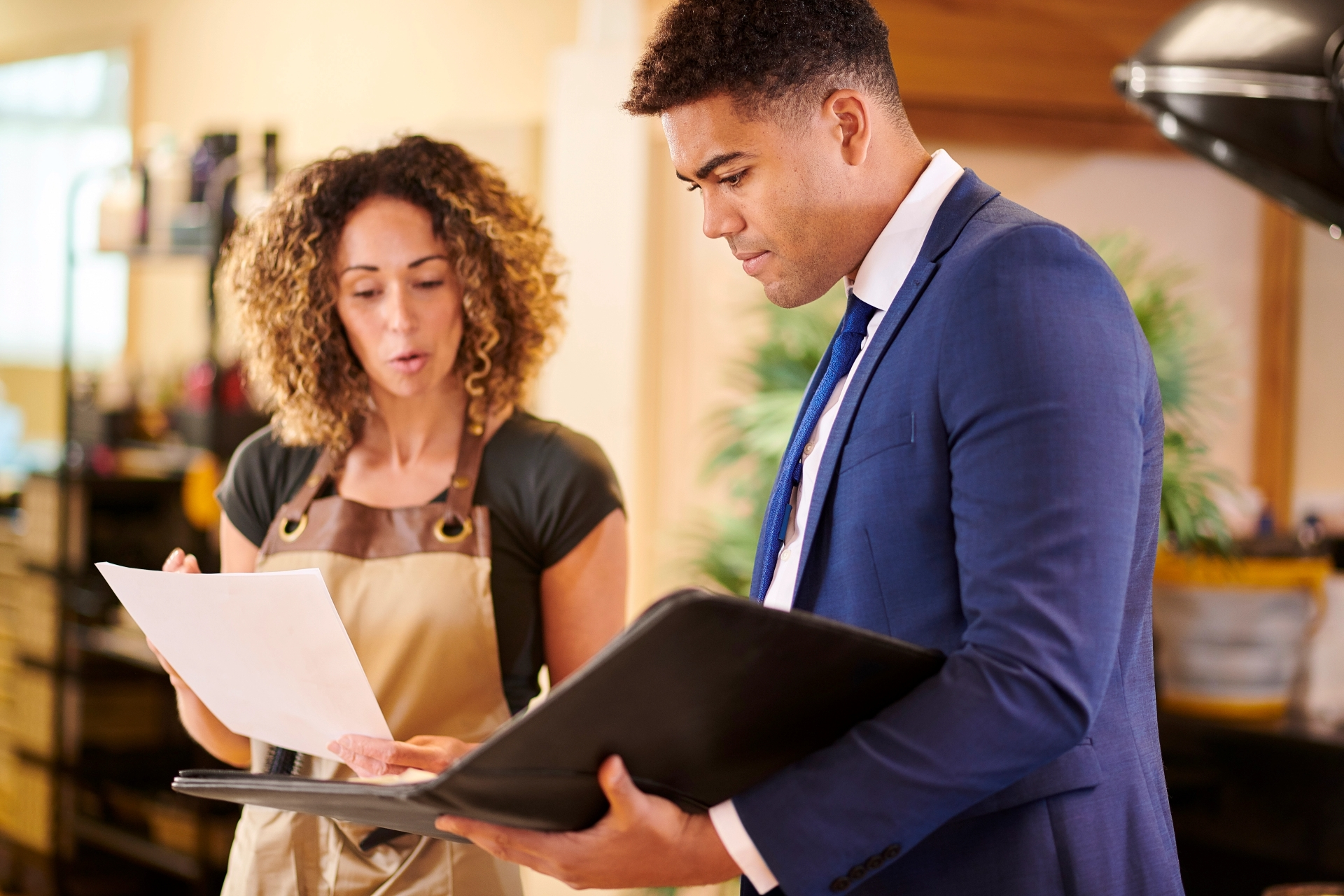 Man and woman looking at paperwork in an office