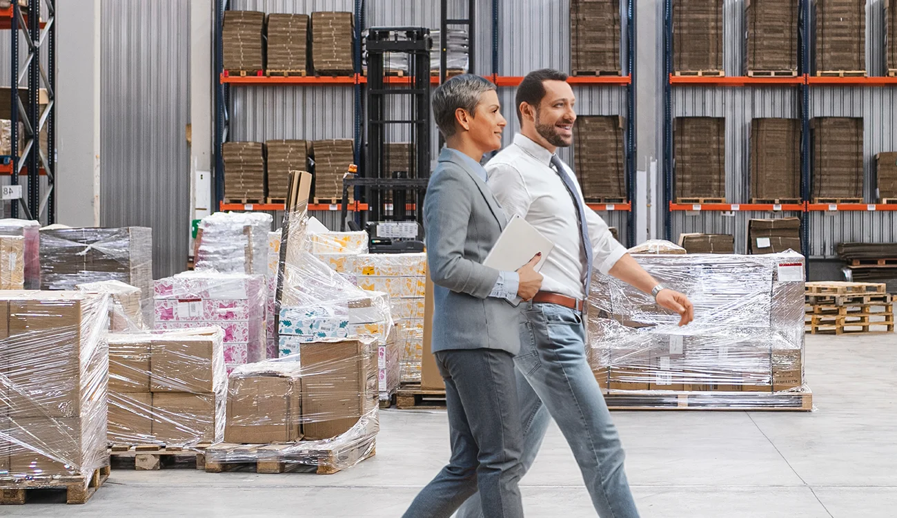 Two people walking side by side in warehouse