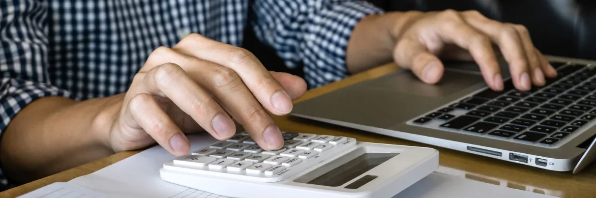 Person entering figures into a calculator