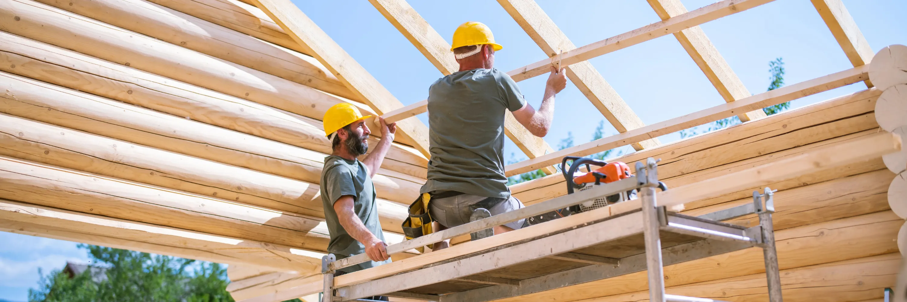Constructors working on a log cabin