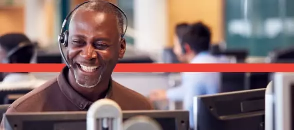 Man smiling in call centre