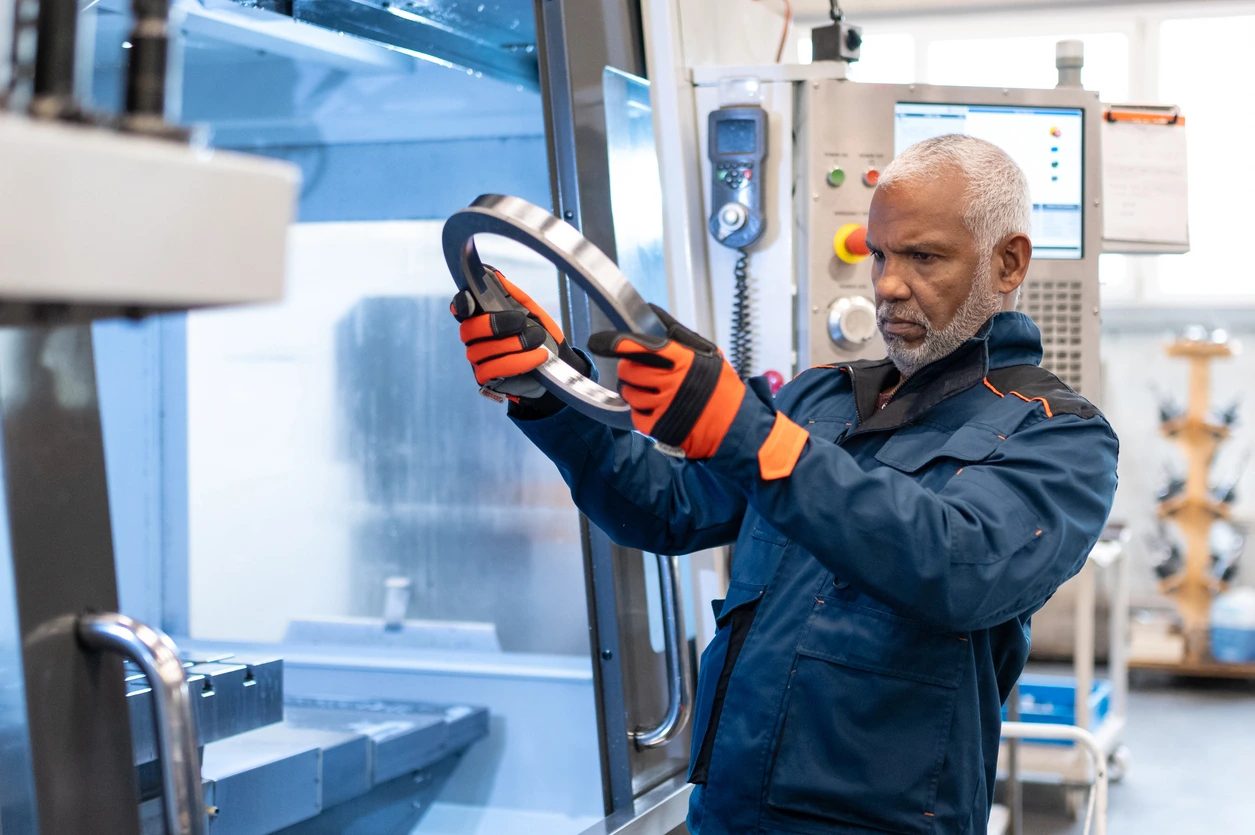 Man looking at metal disk