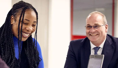 Two people smiling in office
